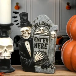 National Tree Company 12 in. Halloween Skeleton Holding a Tombstone Decoration